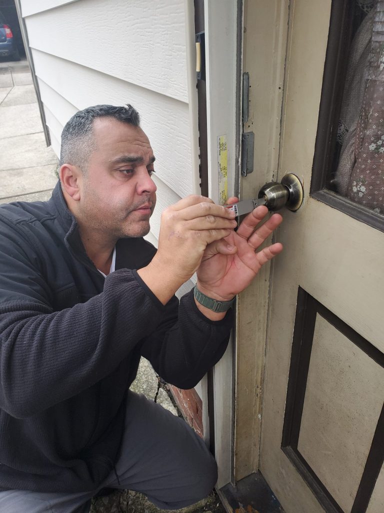 Advanced lock and key technician open a home door lock